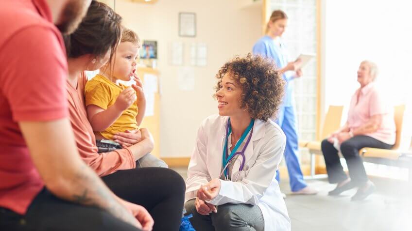 Pediatrician speaking with child patient and his family