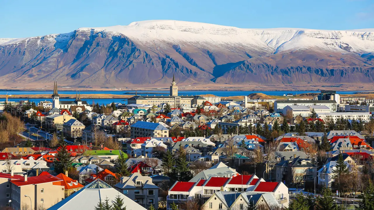 A stunning mountainside view of a town/city in Iceland to show travel aspirations stock photo