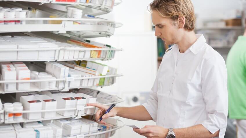 Pharmacy technician searching for prescription pills
