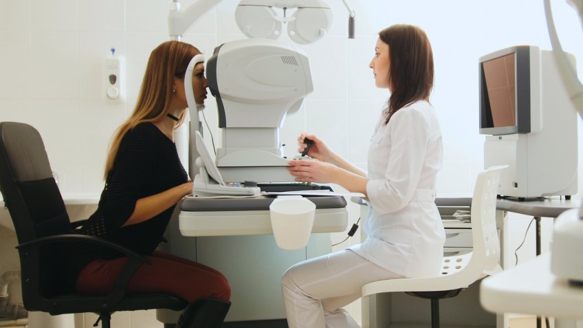 Optician with tonometer and patient at eye clinic, diagnostic, horizontal