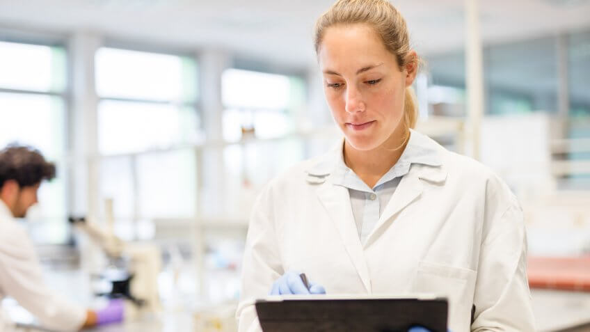 Occupational Health and Safety working with a digital tablet in the laboratory
