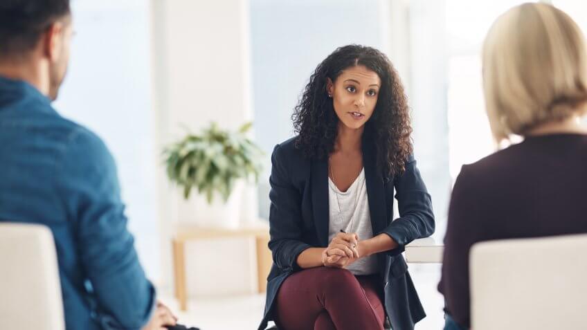 Therapist speaking to a couple during a counseling session