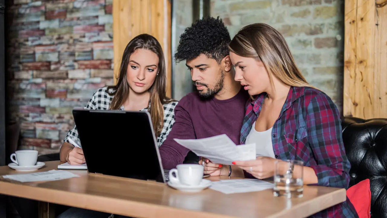 Young multi-ethnic group of people doing a research on student loans.