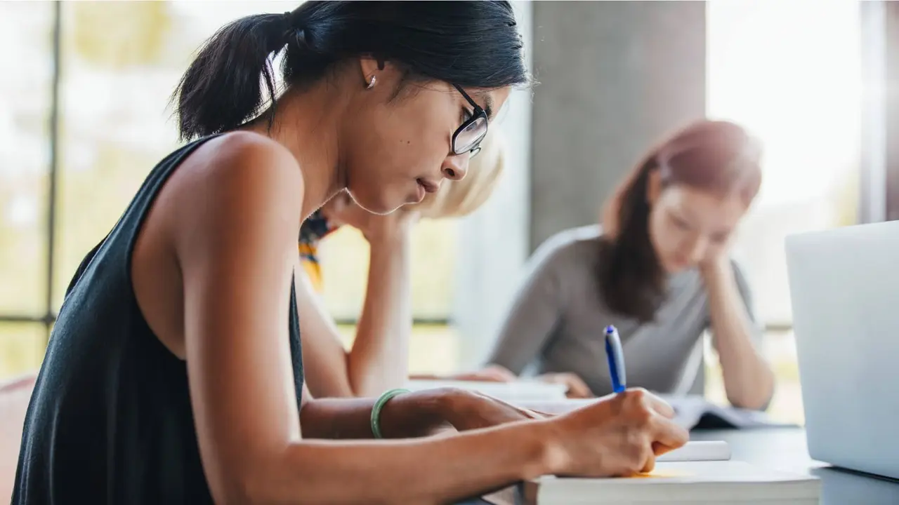 A woman sitting around others while filling out loan application