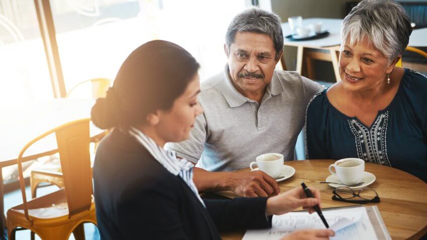 Shot of a senior couple meeting up with a financial advisor.