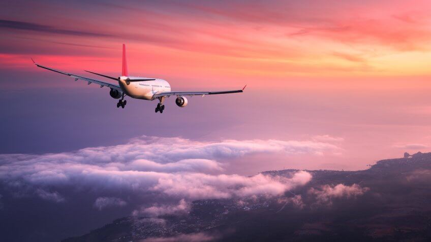 Airplane flying during sunset