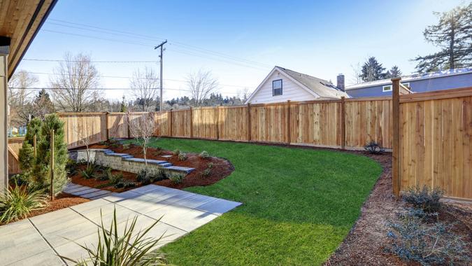 backyard fence lawn shutterstock_557489959