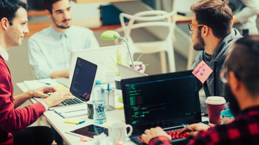 Five young people running their coding startup company.