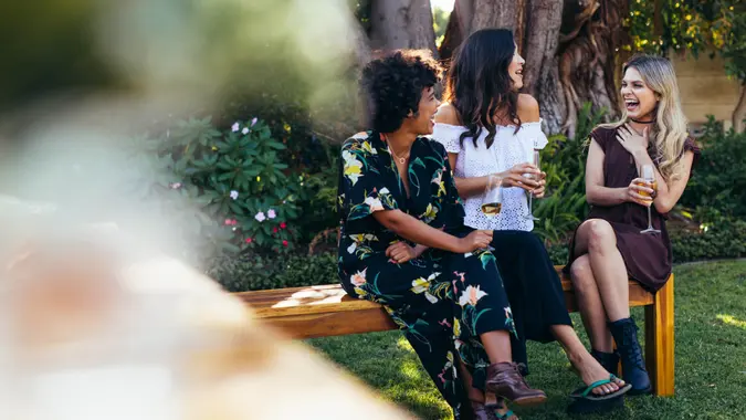 Cheerful young women hanging out with drinks.