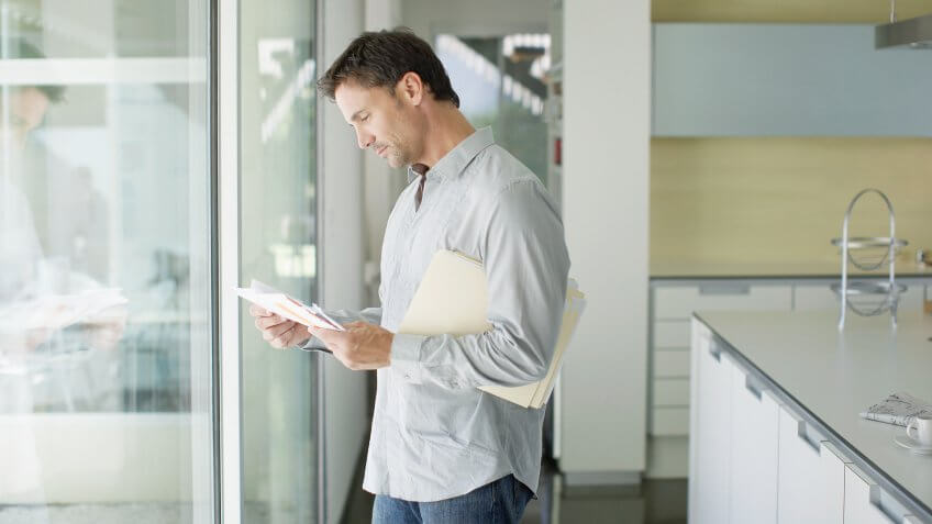 Man sorting mail at home.