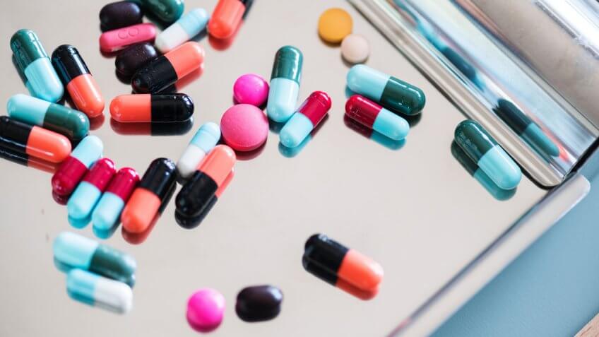 colorful pills on stainless steel tray.