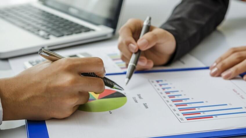 pens pointing at graph
