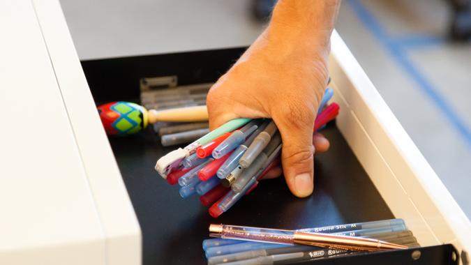 person stealing pens in office