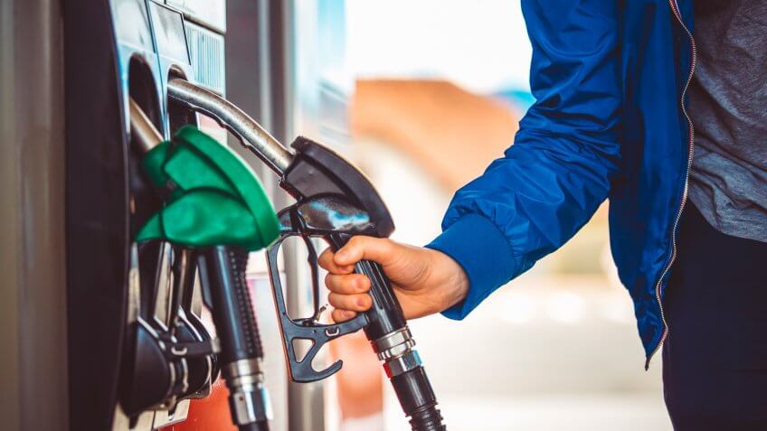 Male hand holding fuel pump nozzle, Diesel Fuel, Car,.