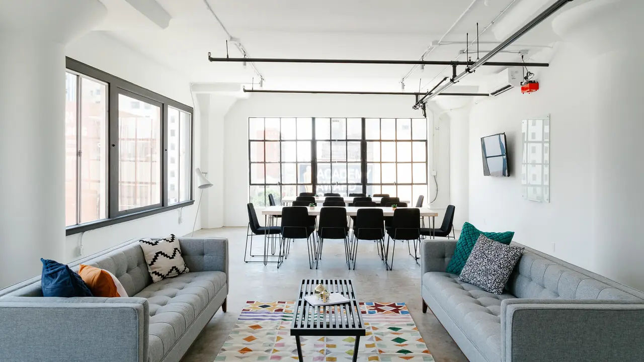 a living room filled with furniture and a large window