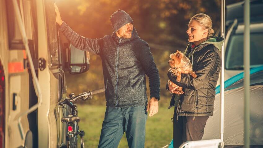 Young Caucasian Couples with Dog Motorhome RV Camping.