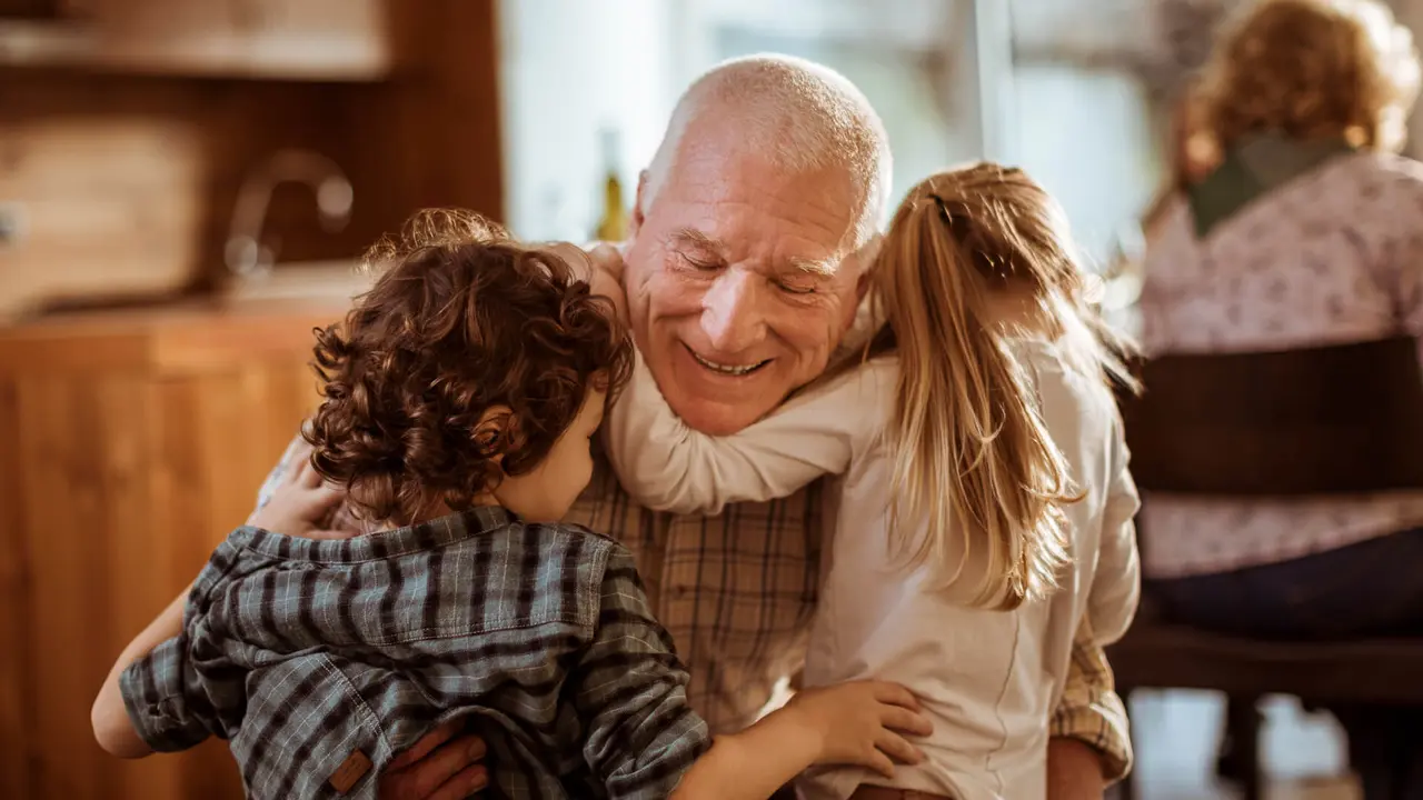 Close up of a grandfather playing with his grandkids.