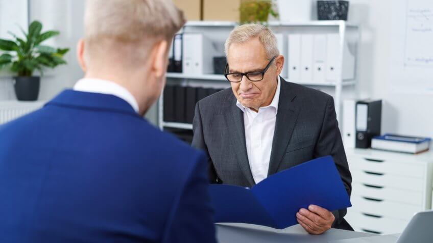 Middle aged hiring manager reviewing resume