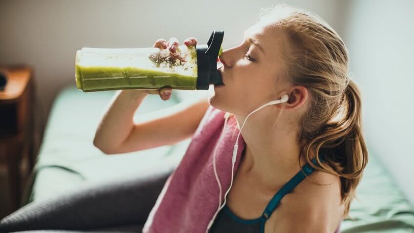 woman drinking detox drink