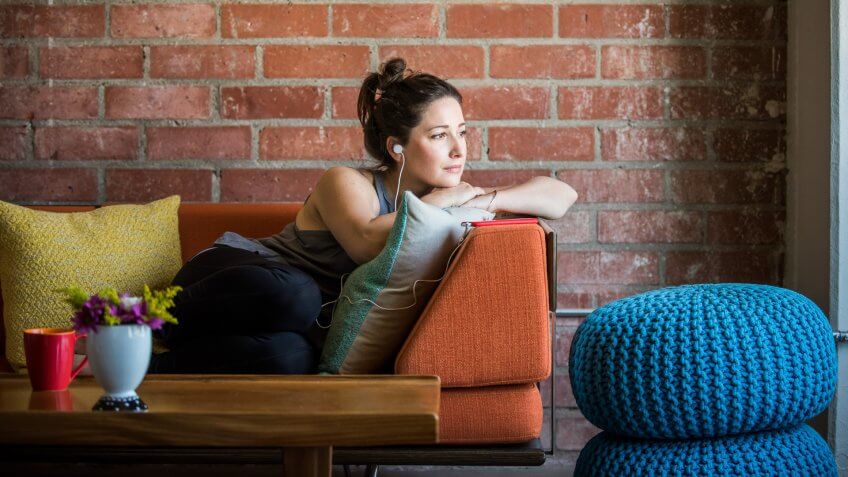 Young Woman Intently Listening to a Podcast