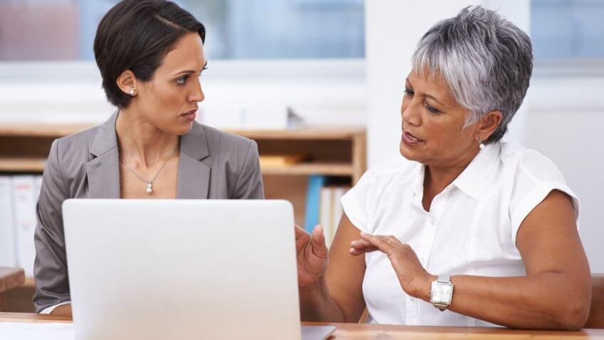 Cropped shot of two female business colleagues having a work discussion.