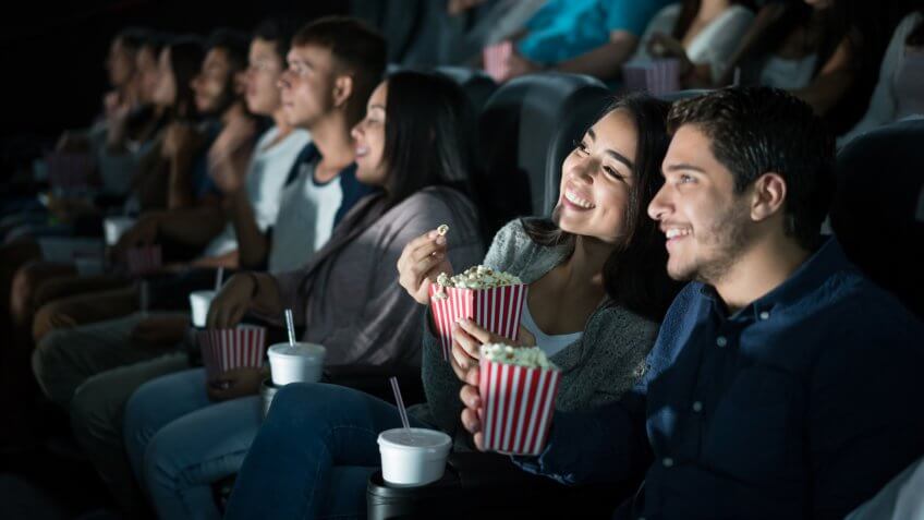 young couple watching movie in theater
