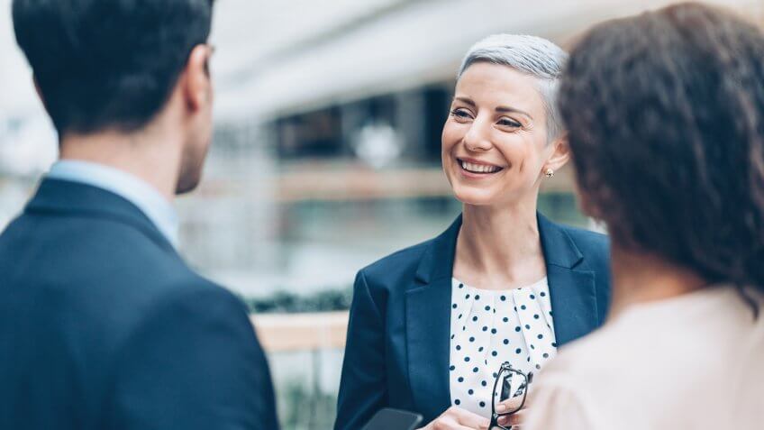 Business persons talking in the lobby.