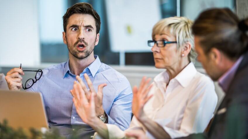 Frustrated entrepreneur discussing with his colleague on a business meeting in the office.