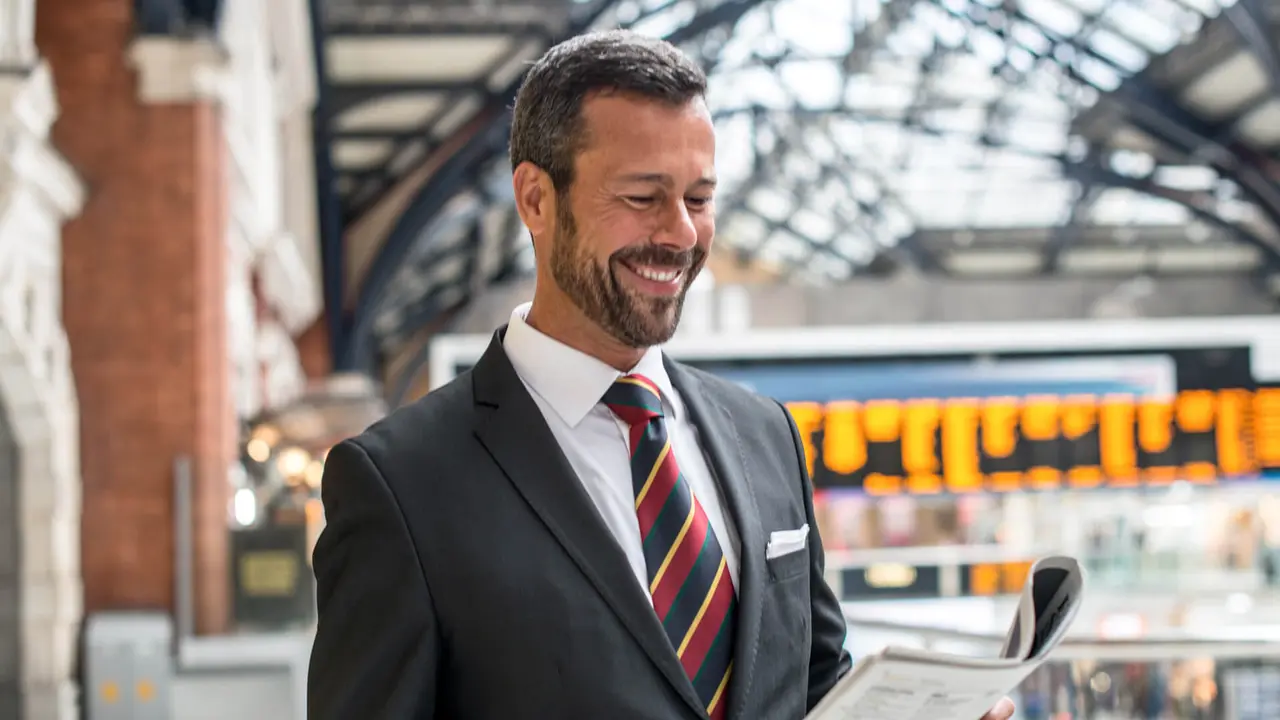 Man in suit reading newspaper