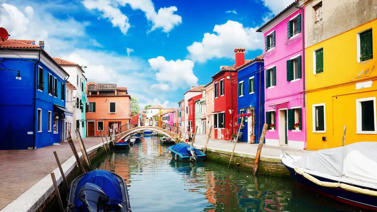 multicolored houses over canal with boats, street of Burano island, Venice, Italy, retro toned.