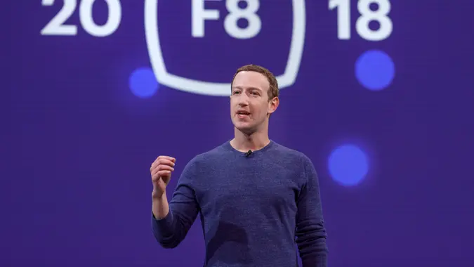 Meta CEO Mark Zuckerberg in a blue shirt, on a stage at F8 2018