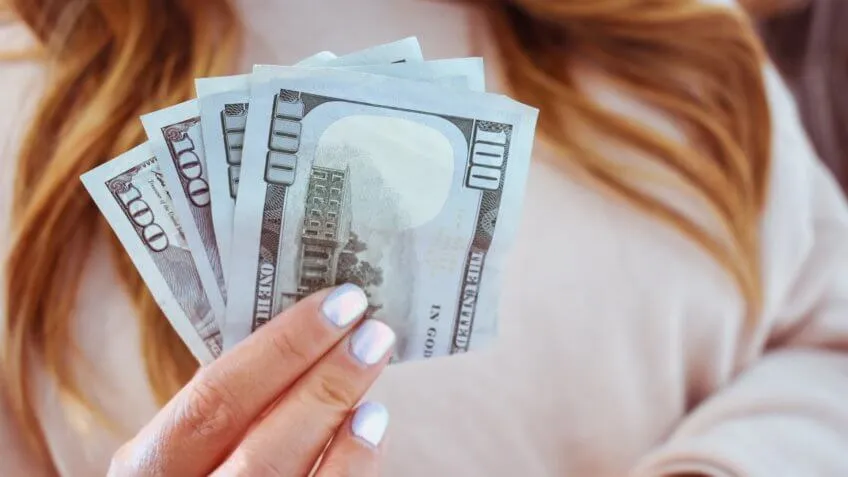 woman holding cash