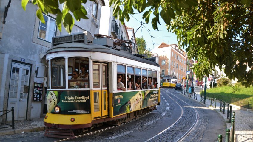 Lisbon, Portugal - September 1st, 2013: Classic yellow trams driving in Lisbon center.