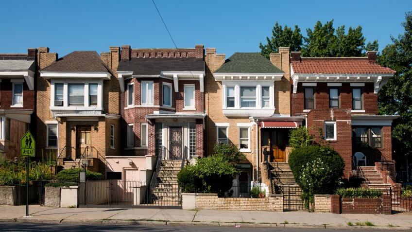 This is a horizontal, color photograph of brick homes in the Astoria neighborhood of Queens, New York.