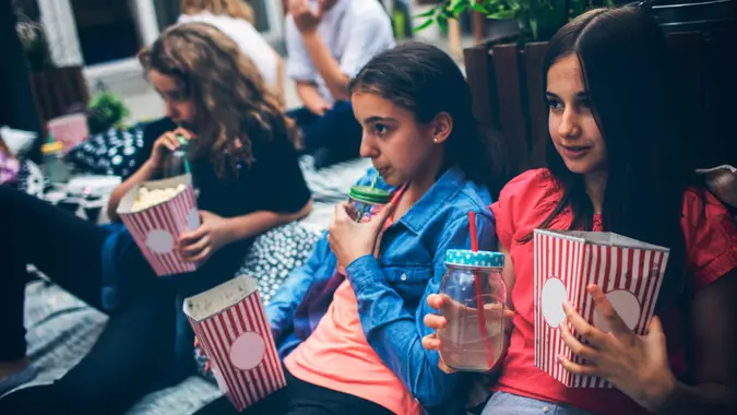 Group of children on movie night in backyard.