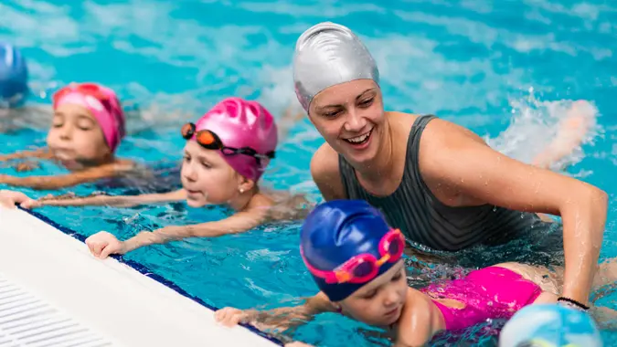 Swimming school - Swimming instructor with children.