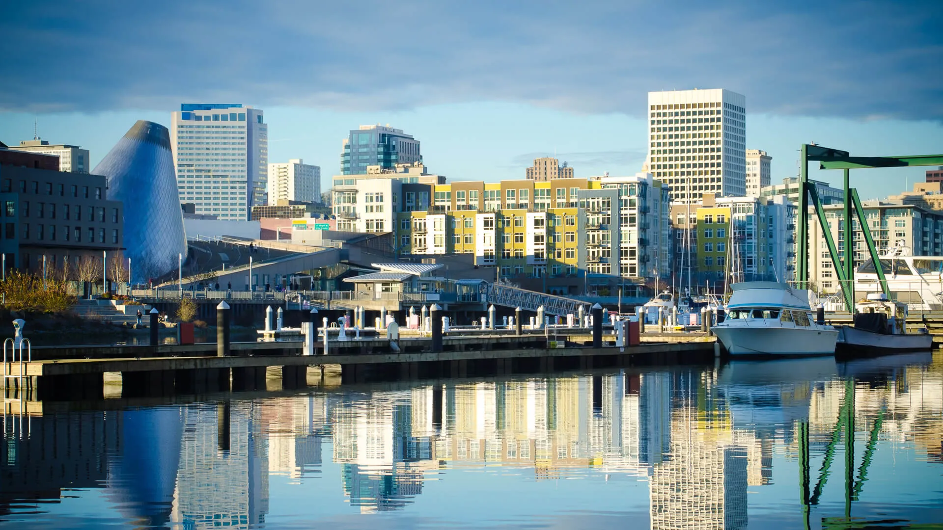 Skyline consisting of office buildings, condominiums and museums of Tacoma, WA reflects off of the Foss Waterway.
