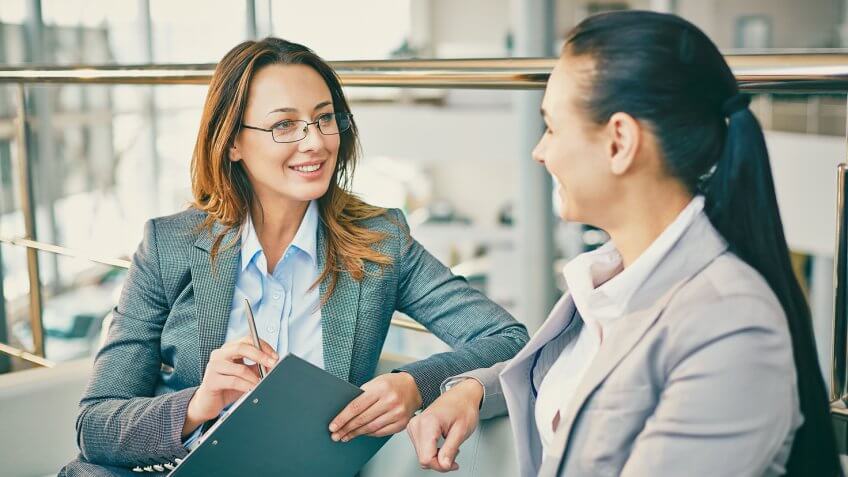 Pretty employees discussing information.