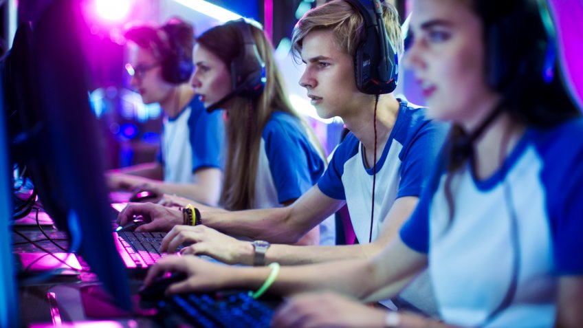 Team of video gamers competing in an eSports arena