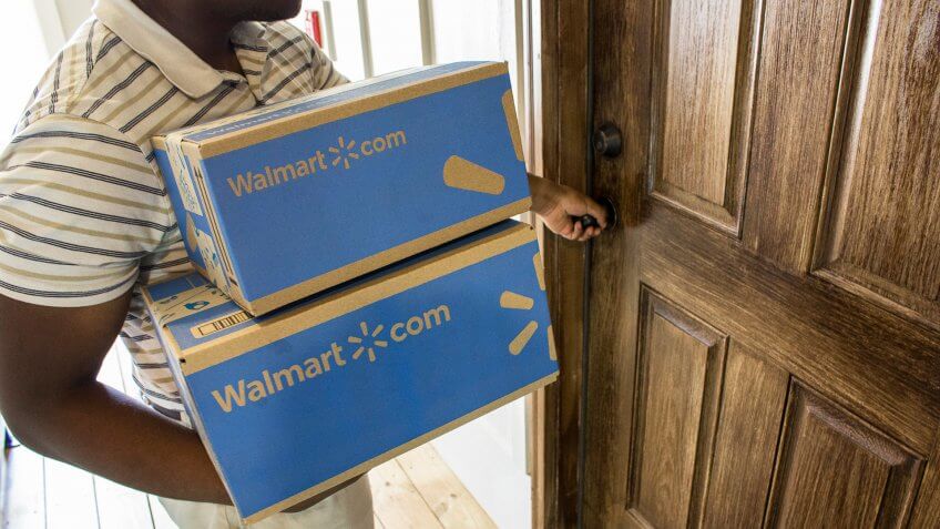 man bringing in Walmart 2-day free shipping packages