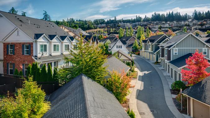 Houses line a Curvy Road that cuts through Residential Neighborhoods in the Issaquah Highlands on an Autumn Morning.