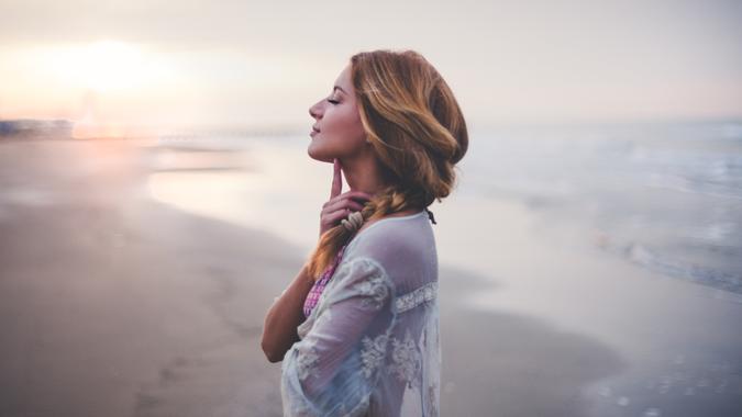 woman at peace with herself at the beach