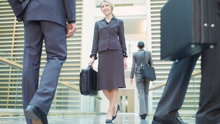 Businesspeople walking in corridor.