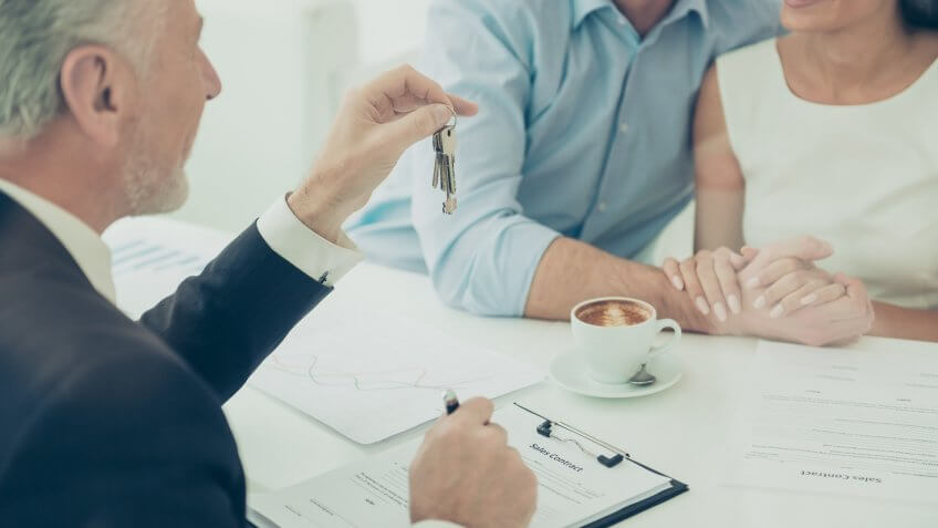 businessman giving couple keys