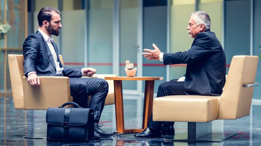 two businessmen meeting in lobby