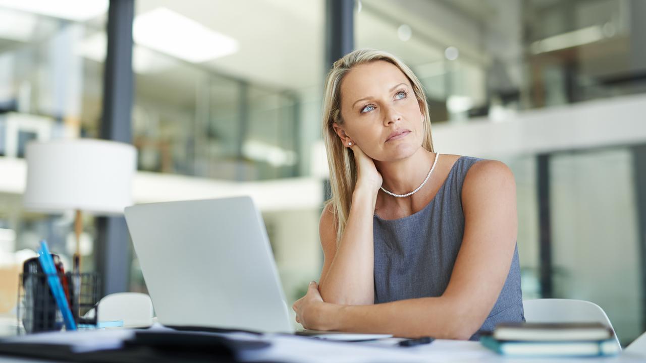 Shot of a mature businesswoman using a laptop in a modern office and looking thoughtful.