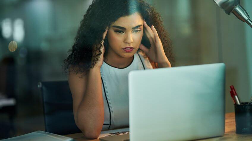 young businesswoman experiencing stress during a late night at work