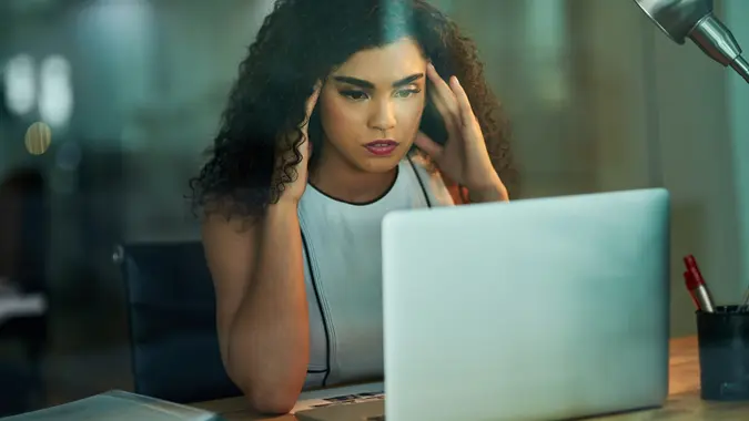 young businesswoman experiencing stress during a late night at work