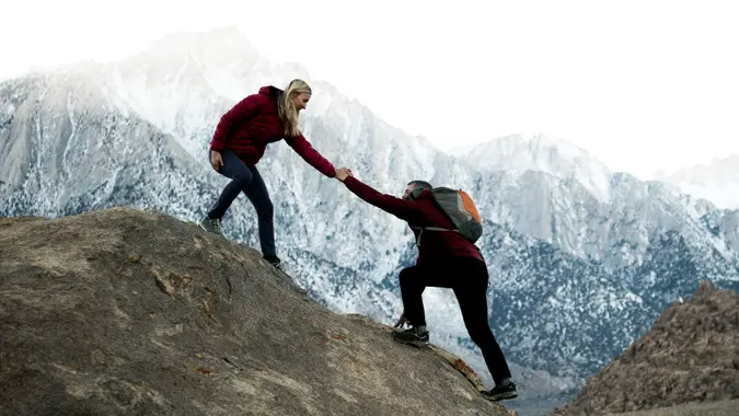 couple hiking steep mountain