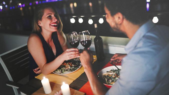Beautiful couple in love having romantic dinner at night.
